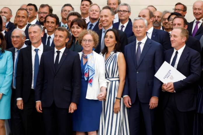 French President Emmanuel Macron poses for a family picture after holding consultative talks ahead of the Biarritz G7 summit, at the Elysee Palace in Paris