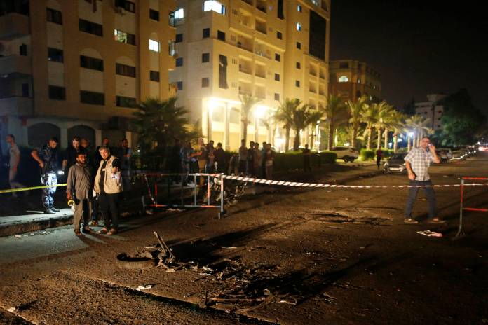 Palestinians check the scene following an explosion in Gaza City