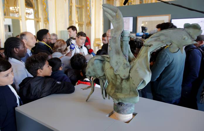 The iconic copper rooster, which was perched at the top of the spire of Notre-Dame Cathedral for more than a century is displayed at the exhibition