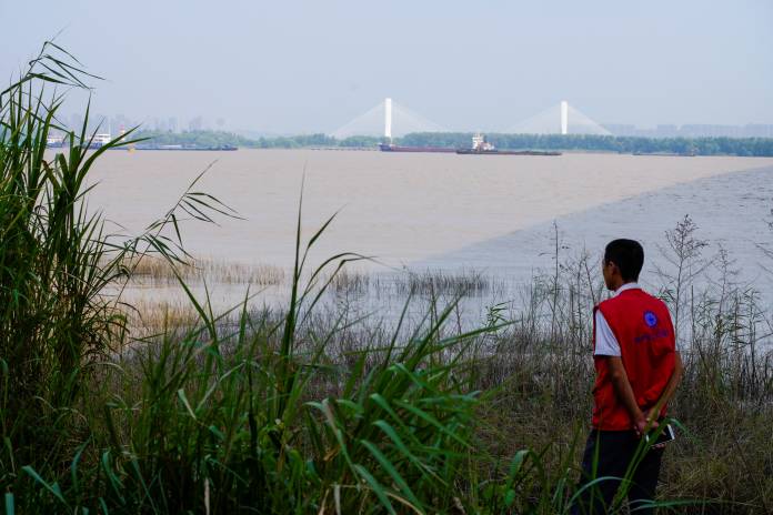 A conservationist keeps watch over porpoises at the Yangtze river near the city of Nanjing