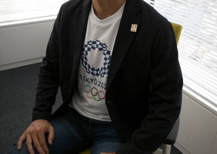 FILE PHOTO: Employee of Asics Corp poses for a photograph during an interview with Reuters in Tokyo