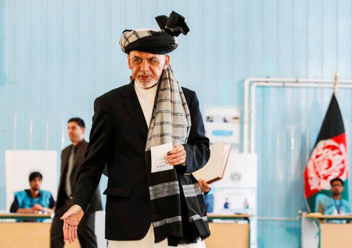 Afghan presidential candidate Ashraf Ghani arrives to cast his vote in the presidential election in Kabul, Afghanistan
