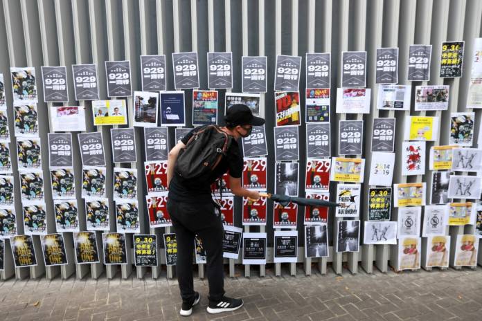 Anti-government protesters build a Lennon Wall in Hong Kong