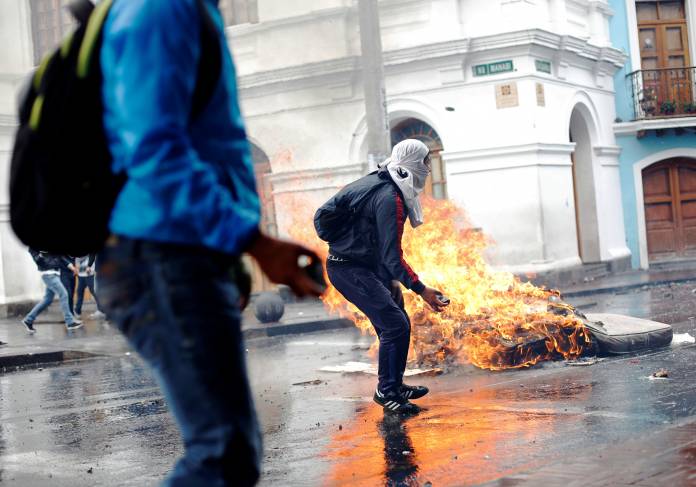Demonstrators clash with riot police during protests after Ecuador's President Lenin Moreno's government ended four-decade-old fuel subsidies, in Quito