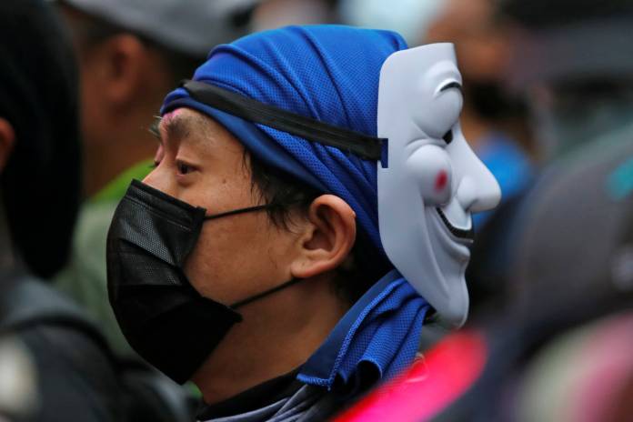 Protesters wearing masks gather during an anti-government rally at Causeway Bay, in Hong Kong