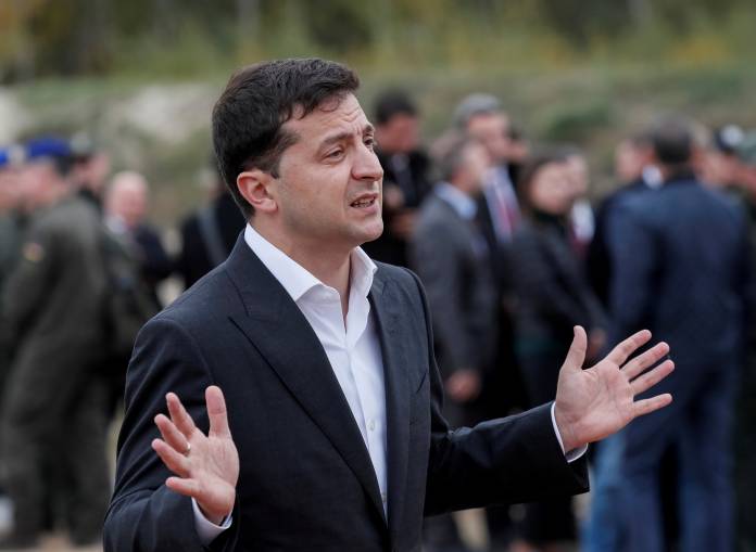 FILE PHOTO: Ukrainian President Zelenskiy speaks with journalists during a joint drill of departments of Interior Ministry at the International training Centre near the village of Stare