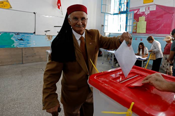 Man casts his ballot at a polling station during parliamentary elections, in Tunis
