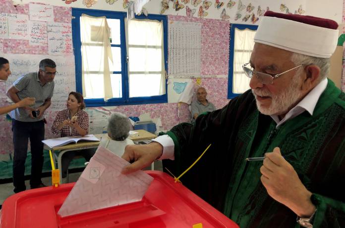 Abdel Fattah Mourou, vice-president of the moderate Islamist Ennahda party, casts his ballot at a polling station during the parliamentary elections in Tunis