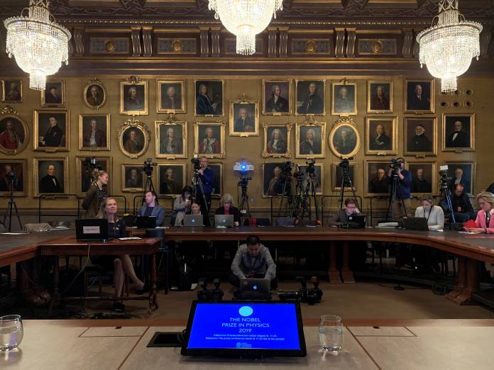 Journalists get ready for the announcement of the winner of the 2019 Nobel prize for physics at the Royal Swedish Academy of Sciences in Stockholm