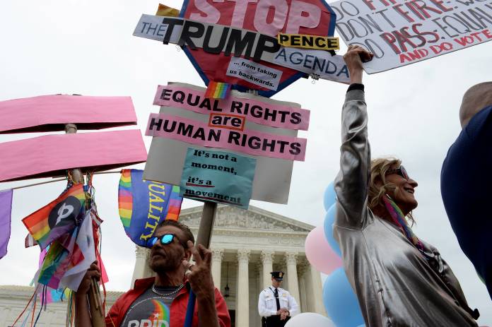 LGBTQ activists and supportersrally on the steps of the U.S. Supreme Court in Washington