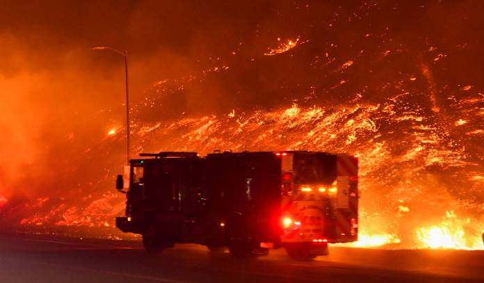 Firefighters battle a wind-driven wildfire in Sylmar, California