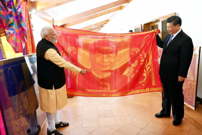 India's Prime Minister Narendra Modi and China's President Xi Jinping exchange gifts in Mamallapuram