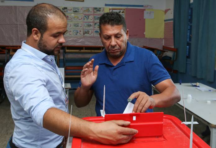 A man casts his vote at a polling station in Tunis
