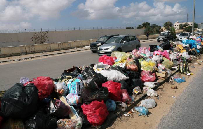 A mound of rubbish is seen left on a sidewalk in Tripoli,
