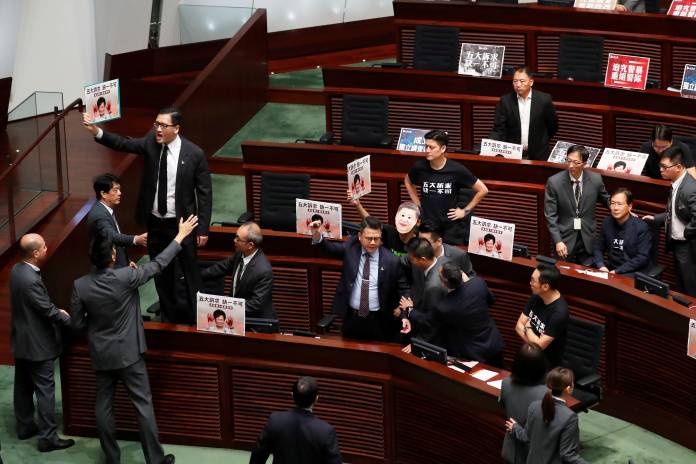 Lawmakers protest as Hong Kong Chief Executive Carrie Lam arrives to deliver her annual policy address, at the Legislative Council in Hong Kong