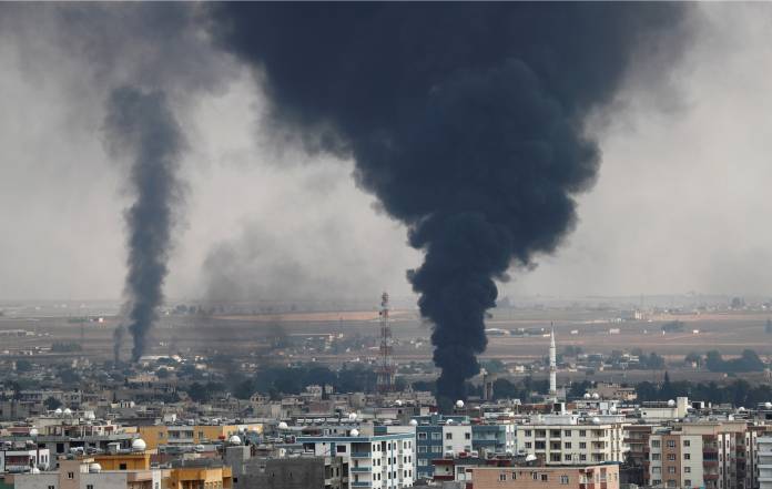 Smoke rises over the Syrian town of Ras al Ain, as seen from the Turkish border town of Ceylanpinar