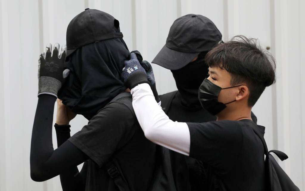 China stops couriers from shipping black clothing to Hong Kong amid