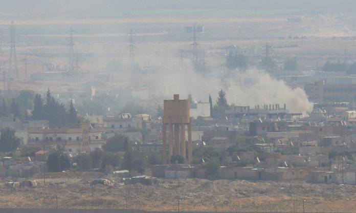 Smoke rises over the Syrian town of Ras al-Ain as seen from the Turkish border town of Ceylanpinar