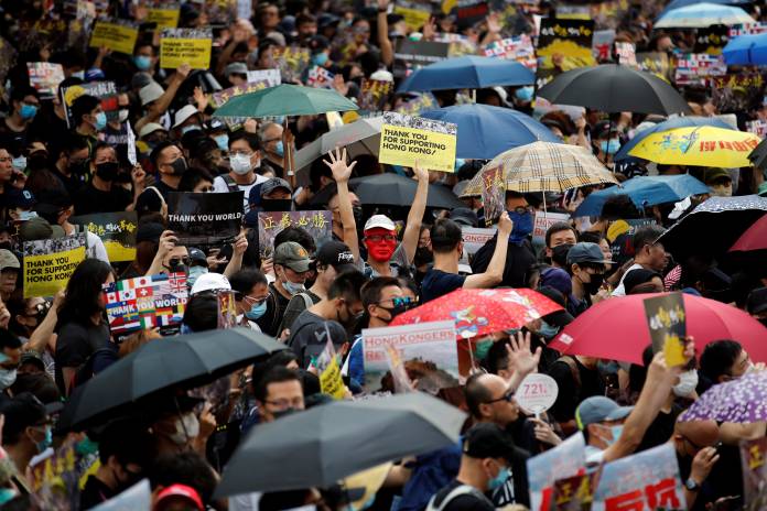 Anti-government protesters take part in a protest in Hong Kong's tourism district of Tsim Sha Tsui