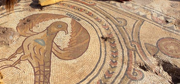 Two Israel Antiquities Authority workers clean a mosaic floor in the remains of a 1500-year-old church in Ramat Beit Shemesh
