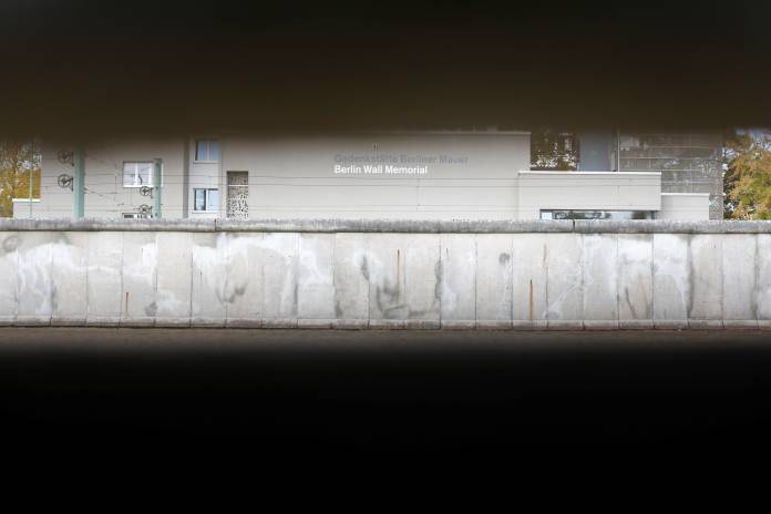 The former death strip is pictured through Wall segments at the Berlin Wall memorial on Bernauer Strasse in Berlin