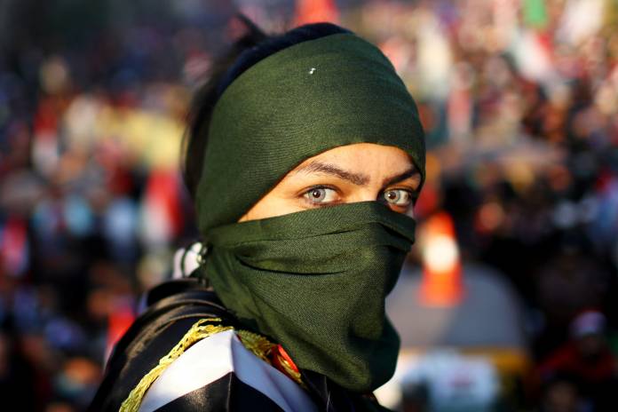 An Iraqi female demonstrator takes part in ongoing anti-government protests in Baghdad