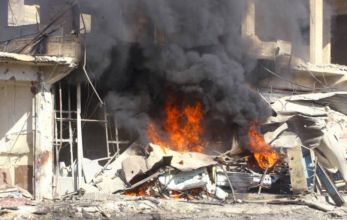 Smoke rises at a site of a bomb explosion in the town of Suluk