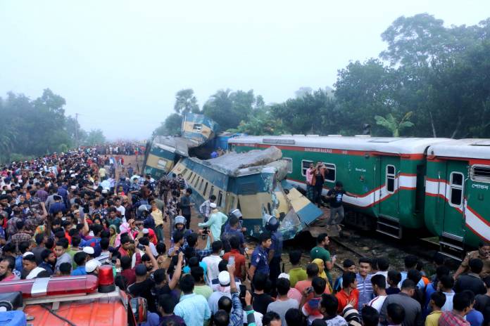 People gather at the site where two train collided in Brahmanbaria