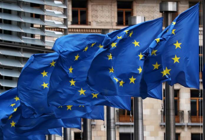 EU flags fly outside the European Commission headquarters in Brussels