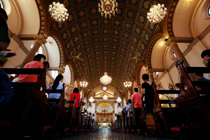 Catholics pray in Santa Cruz Church, ahead of Pope Francis' visit to Thailand, in Bangkok