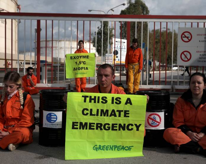 Greenpeace activists block the entrance of the Hellenic Petroleum refineries in Aspropyrgos near Athens