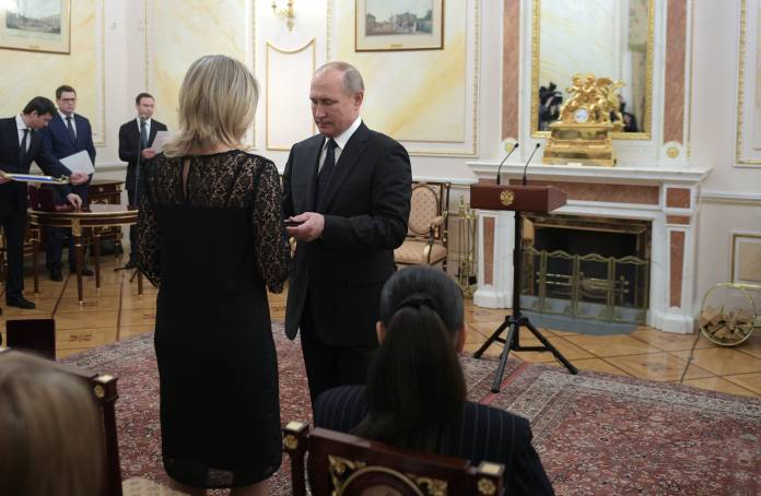 Russian President Vladimir Putin hands the Order of Courage to a widow of a man killed in an accident during a military test outside Severodvinsk in August 2019, in Moscow