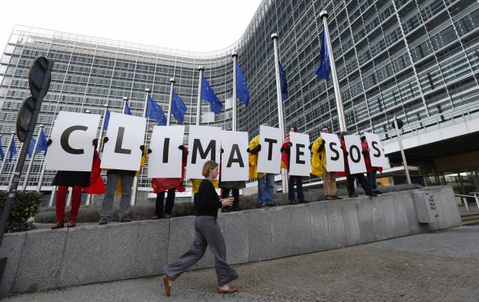 Members of environmental associations gather to demand improvements in climate change and energy models, outside the European Commission headquarters in Brussels