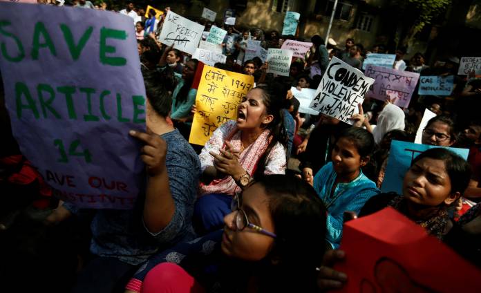 Students hold placards and shout slogans in solidarity with Jamia Millia Islamia university students, in Mumbai