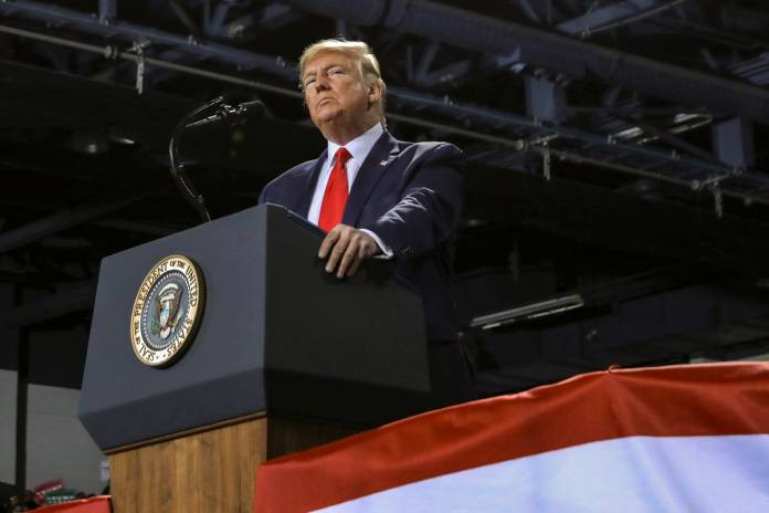 U.S. President Donald Trump looks on during a campaign rally in Battle Creek, Michigan