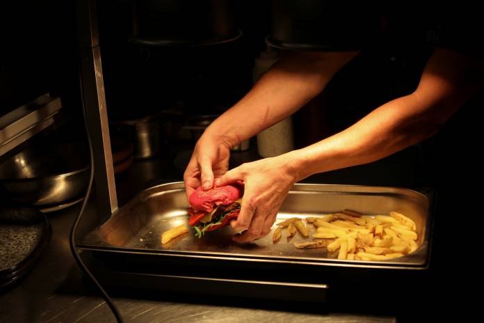 A chef prepares vegan food in the Green Grill section of the Green Vic, which is aiming to be the world's most ethical pub, in Shoreditch, London