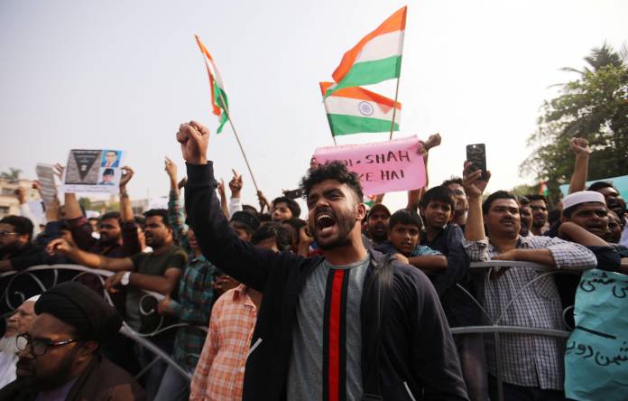 Demonstrators hold placards and shout slogans during a protest against a new citizenship law in Mumbai