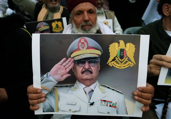 FILE PHOTO: A Libyan man carries a picture of Khalifa Haftar during a demonstration to support Libyan National Army offensive against Tripoli