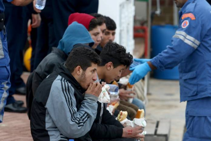 Syrian refugees are seen after disembarking from a Cyprus coast guard boat off the south-east of the island in the region of Protaras