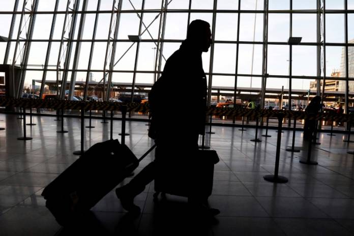 FILE PHOTO: International travelers arrive at John F. Kennedy international airport in New York