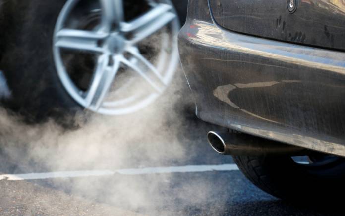 FILE PHOTO: An exhaust pipe of a car is pictured on a street in a Berlin