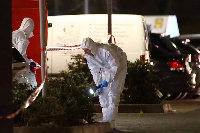 Forensic experts search the area after a shooting in Hanau near Frankfurt