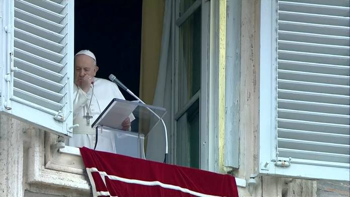 Pope Francis coughs as he leads the weekly Angelus prayer in St Peter's Square at the Vatican