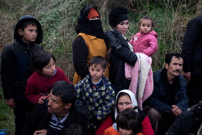 Migrants from Afghanistan are seen following their arrival on a beach, after crossing part of the Aegean Sea from Turkey to the island of Lesbos