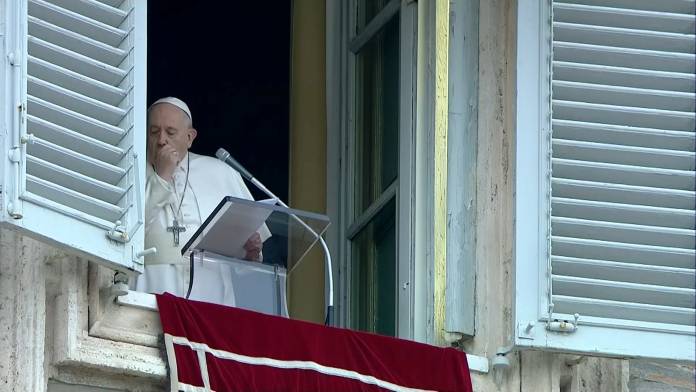 Pope Francis coughs as he leads the weekly Angelus prayer in St Peter's Square at the Vatican
