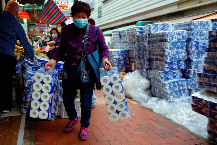 FILE PHOTO: File picture of a customer picking up rolls of toilet paper at a Hong Kong market