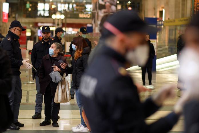Police officers make checks on people at Milan's main train station Police officers make checks on people at Milan's main train station
