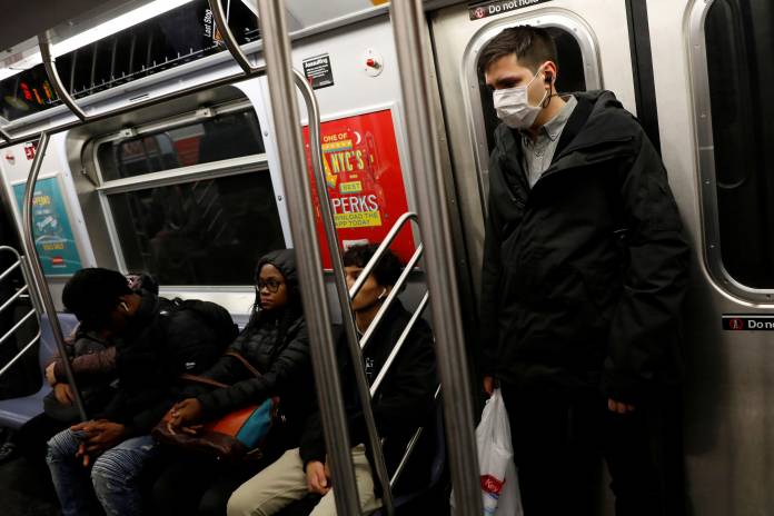A man in a face mask rides the subway in Manhattan, New York City, after further cases of coronavirus were confirmed in New York A man in a face mask rides the subway in Manhattan, New York City, after further cases of coronavirus were confirmed in New York