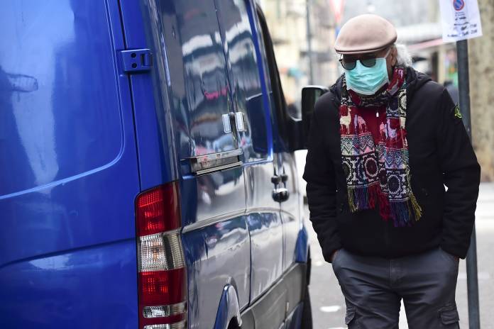 A man with a protective mask walks in Madama Cristina market in Turin A man with a protective mask walks in Madama Cristina market in Turin