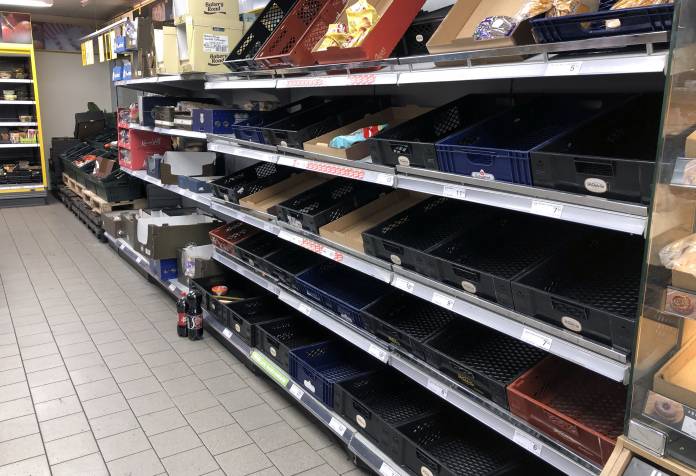 View of empty shelves at a supermarket as people began stockpiling food in Copenhagen View of empty shelves at a supermarket as people began stockpiling food in Copenhagen